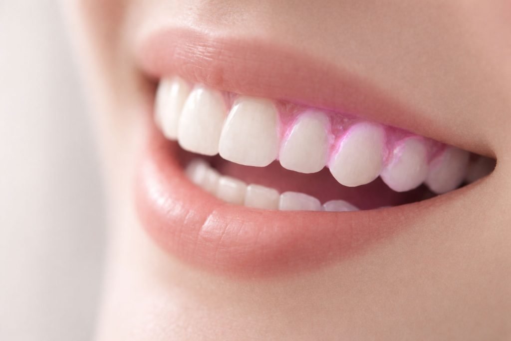 Boca de mujer con revelador de placa bacteriana dental aplicadopresente